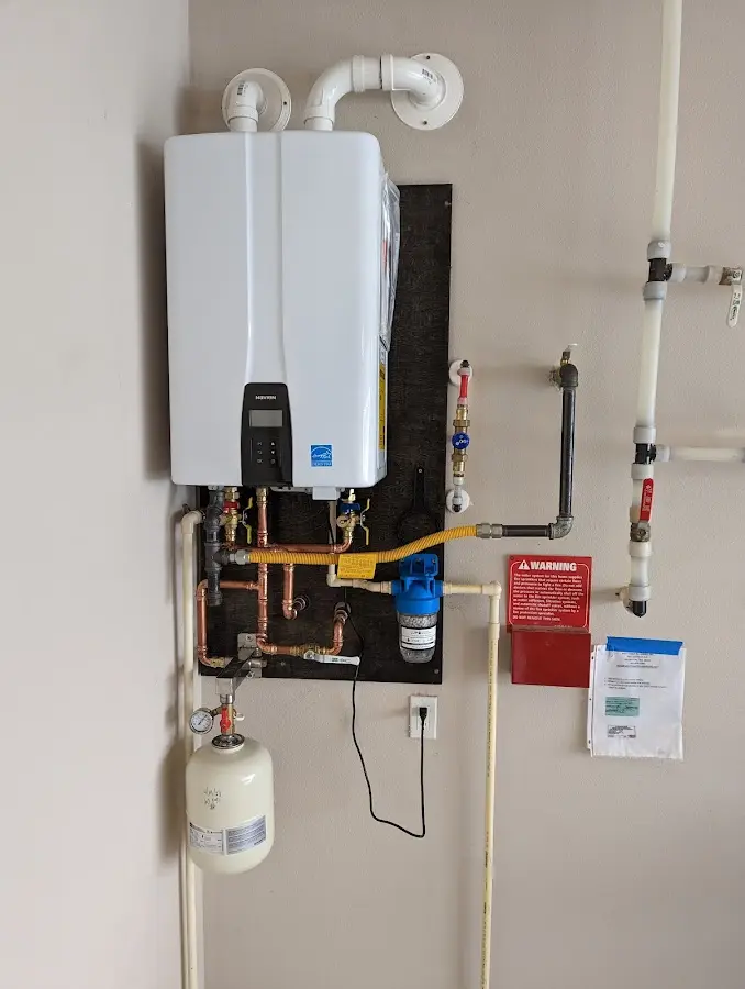 Professional plumber installing copper piping in a Burlingame home